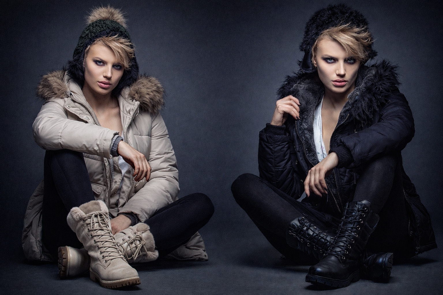 Two confident women wearing tailored black blazers with refined gold jewelry and rich colored satin tops in a luxury European studio setting.